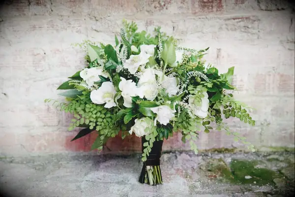 classic spring wedding bouquet with white flowers and greenery