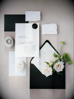 modern spring wedding invitation with black envelope, white floral print envelope liner, black calligraphy and wax seal stamp