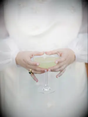 bride holding glass coupe
