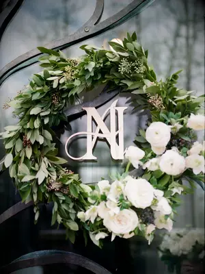 greenery eucalyptus wreath decorated with white flowers and couple