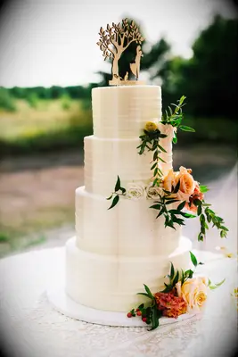 White tiered wedding cake with florals