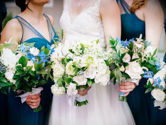 Bride and bridesmaids holding White Spring Rose, Peony and Lilac Bouquets