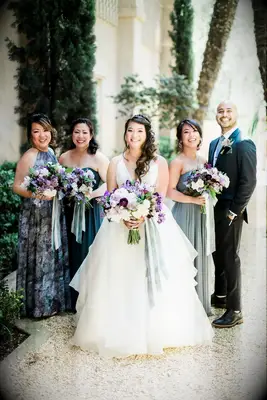Bride and bridal party holding lilac bouquets