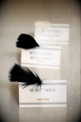 Art deco feathered escort cards for great gatsby themed wedding