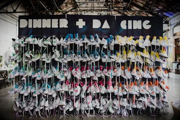 Escort Card and Favor Wall with multicolored canvas sneakers