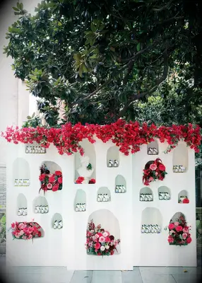 Greek-Inspired Escort Card Wall in bright pink flowers