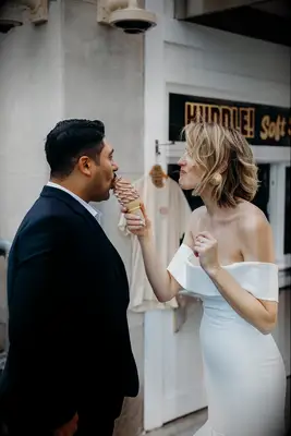 Couple sharing soft serve ice cream cone