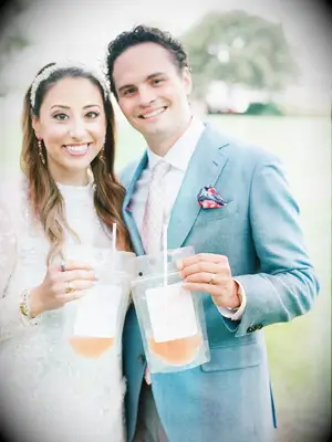 Couple holding wine in drink pouches