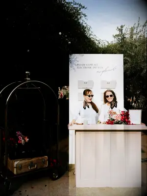 Hotel-inspired phone check station with two people standing behind desk