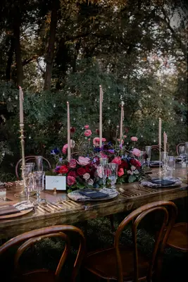 Tall tapered candles in floral arrangement