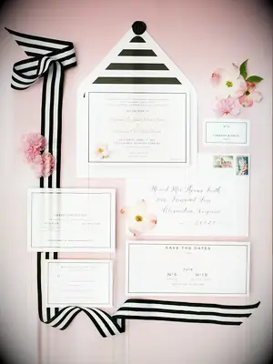 A gorgeously modern wedding stationery suite in pale pinks and black and white stripes.