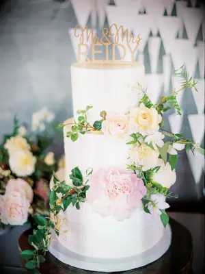 This cake reaches for springtime heights with a pale pink, peach and yellow color scheme.