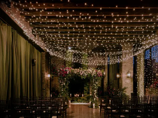 indoor wedding ceremony with twinkle light strands draped across ceiling