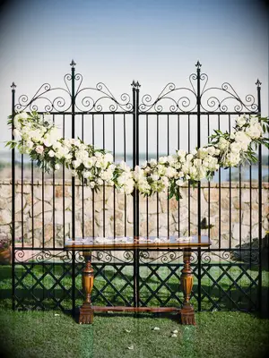 wrought-iron gates ceremony backdrop for outdoor wedding