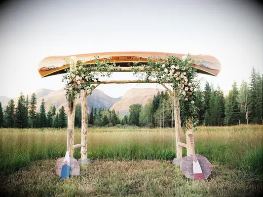 rustic wedding arch alternative made from canoe and tree branch poles