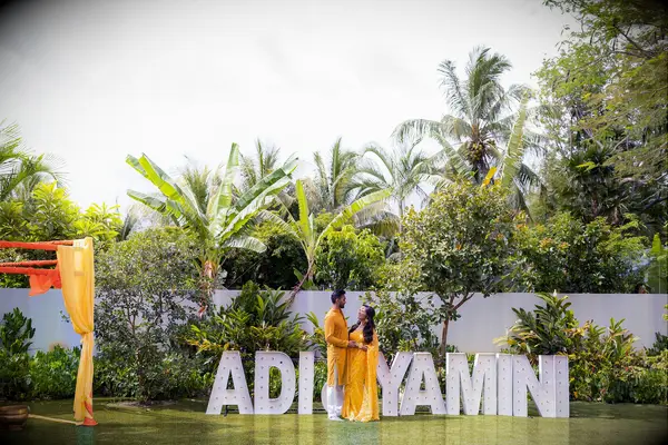 couple beside marquee letters 