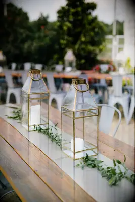 gold lanterns on wood farm table