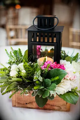 lantern and flower arrangement in wood box