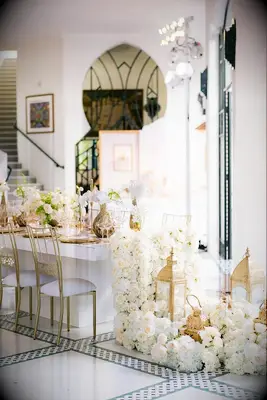 gold lanterns and white roses on wedding table