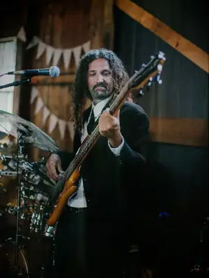 A person playing the bass at a wedding reception. 