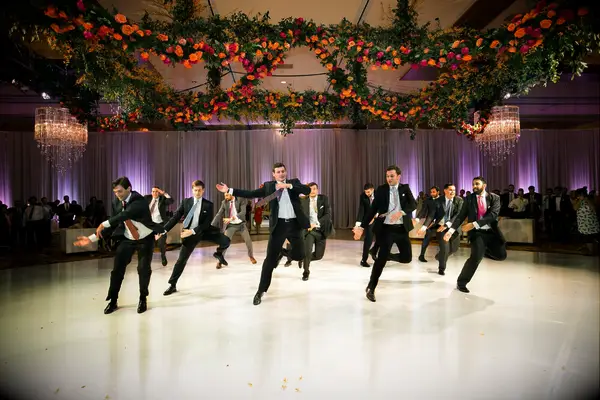 Groomsmen performing a choreographed dance at a wedding reception.