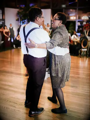 Daughter and mother dancing on the dance floor together. 