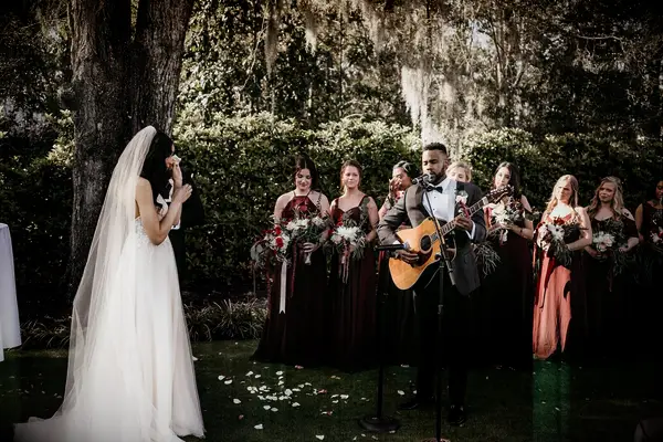 Groom singing to bride during wedding ceremony. 