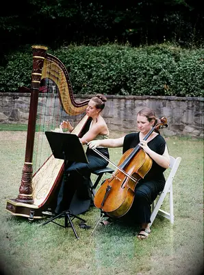 Harpist and cellist playing at a wedding ceremony. 