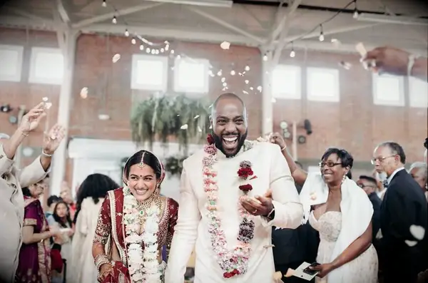 A bride and groom walk hand in hand