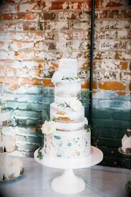 modern semi naked wedding cake with geometric shapes on fondant bottom tier 