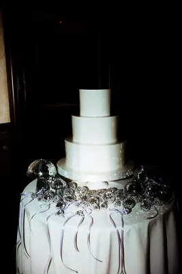 Modern white wedding cake with disco decor