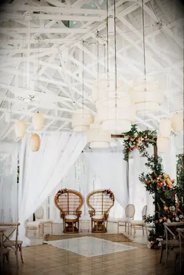 Boho mandap with woven chandeliers and peacock chairs