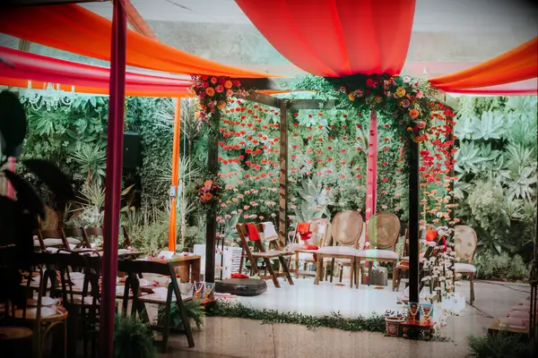 Mandap with vibrant orange fabric accents