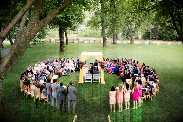 Yellow mandap at ceremony in the round