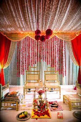Gold-and-red mandap with lots of decorations