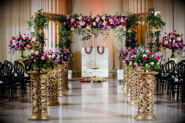Gold-and-purple mandap in ballroom