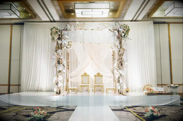 All-white mandap in hotel ballroom