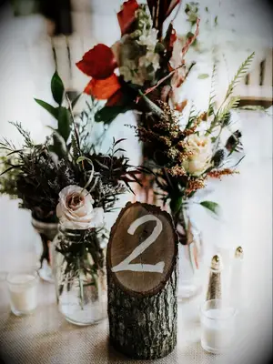 Wooden stump centerpieces at a fall wedding