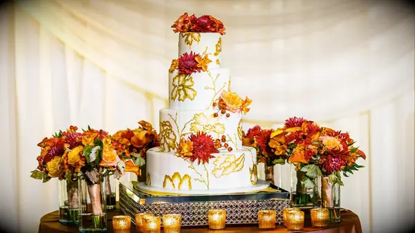 Gold-painted fall-themed wedding cake
