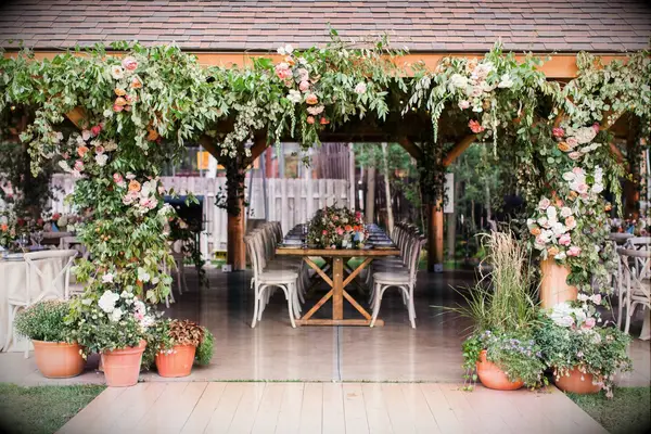 Pavilion wedding reception with greenery entryway arch installation
