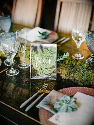 Pressed fern in frame as table number
