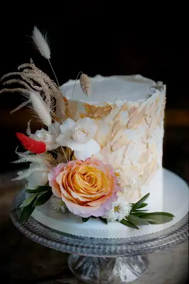 Textured beige wedding cake with flower decorations
