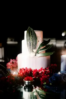 White wedding cake with tropical leaves