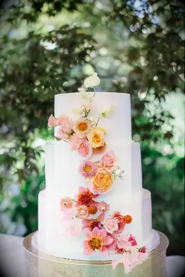 Three-tier cake with ombre cascade of fresh flowers.