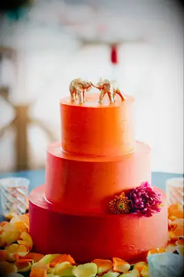 Three-tier bright orange wedding cake