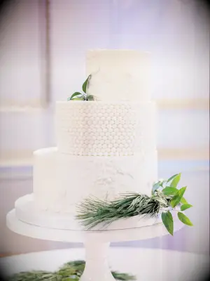 Three-tier white staircase wedding cake