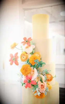 Pale yellow spring wedding cake with flowers