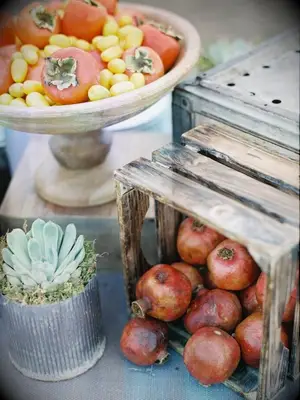 fresh produce centerpiece with persimmons and pomegranates 