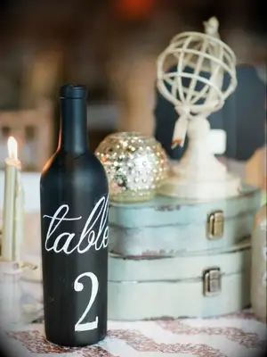 centerpiece with wine bottle and vintage suitcases