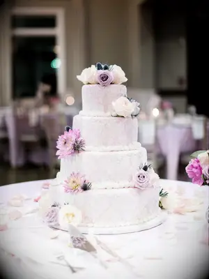 A purple Jordan almond-flavored wedding cake at a wedding ceremony.